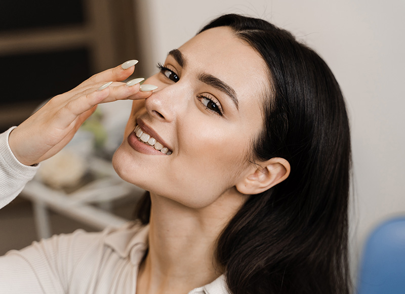 Girl touches her nose